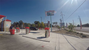 A wide view of vacuum stations outside of the car wash on a sunny day