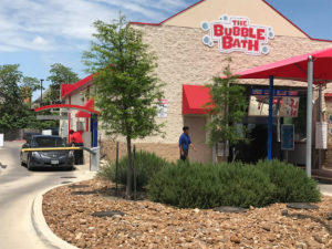 The Bubble Bath car wash in operation on a sunny day.